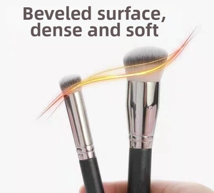 Detail of soft dense angled concealer and foundation brushes with matte black handles