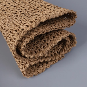 Detailed close-up of handmade hollow woven paper straw texture on a bucket sun hat