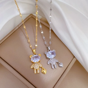 Luxurious teddy bear pendant necklace with zircon stone and heart detail on jewelry box