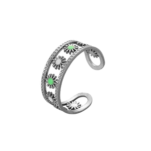 Detail of adjustable open ring featuring white and green enamel daisy flower charms