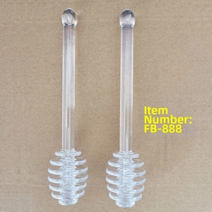 Détail de deux bâtons à miel transparents en verre borosilicate avec tête spirale typique