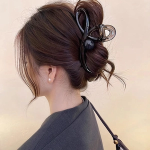 Black large hair claw clip with transparent bow and bead, elegant updo style for women