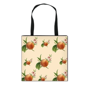 Foldable canvas peach fruit tote bag with vintage botanical print and black shoulder straps