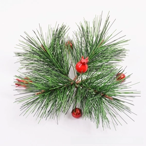 Close-up of artificial pine needles with bright red berries for Christmas floral decor