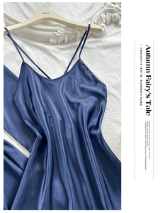 Detail of navy blue silk satin camisole dress with thin straps on a brand hanger