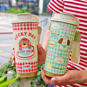 Detailed view of vacuum insulated coffee mugs with cute dog patterns and fabric straps