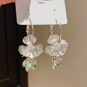 Detailed macro view of S925 silver floral earrings with crystal fringe and zircon accents