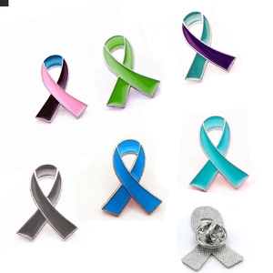 Detail showing the butterfly clutch backing and colorful enamel awareness ribbon pins
