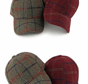 Detail view of winter plaid wool baseball caps in brown-grey and burgundy checkered patterns