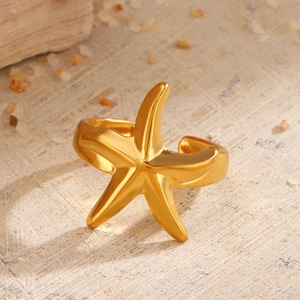 Irregular lava starfish open ring in gold finish on natural stone background