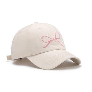 Chic beige cotton baseball cap with pink bow embroidery and curved brim for women