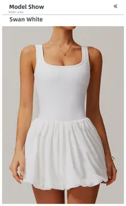 Detail of swan white athletic dress featuring square neck design and pleated skirt