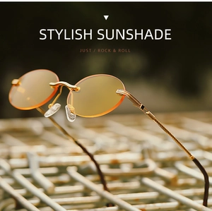 Detail of rimless oval sunglasses with orange-yellow lenses and gold metal temples