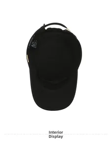 Detail view showing interior stitching, lining and care label of black flat top cadet cap