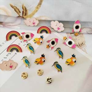 Detailed close-up of colorful cartoon enamel bird pins and creative alloy brooch set
