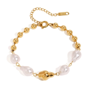 Elegant gold bead bracelet featuring irregular white pearls and a textured metal charm