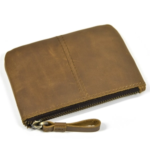 Close-up of brown genuine leather coin purse with zipper closure and detailed stitching