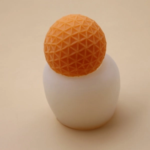 Macro detail of silicone mold showing geometric triangle pattern on sphere candle