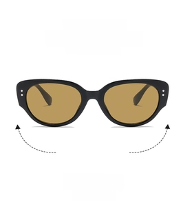Detail view of retro cat-eye sunglasses with thick black frames and amber tinted lenses