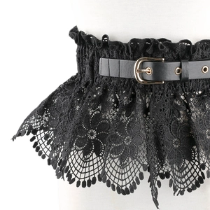 Detail of floral lace corset belt with faux leather strap and metal buckle on mannequin