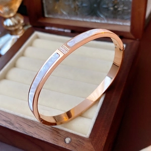 Elegant rose gold titanium bracelet featuring shell inlay and sparkling crystal accents