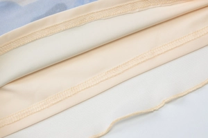 Macro detail of beige lining and blue mesh fabric with professional double-stitched seams