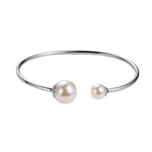 Minimalist silver bangle with asymmetrical double white pearls on a clean white background