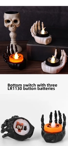 Detail view of the battery compartment and bottom switch on LED skeleton hand candle lights