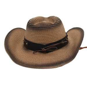 Detail of woven straw cowboy hat with brown leather band and metallic gold studs
