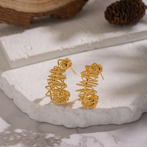 Golden irregular hollow wire wrap stud earrings in a bird nest artistic design