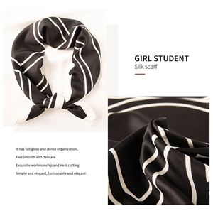 Detail of black and white striped silk scarf showing fabric texture and neat stitching