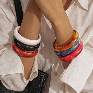 Stack of vintage resin chunky round bangles in amber, red and ivory for women