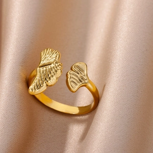 Detail of 18k gold plated ginkgo leaf open ring on champagne silk background