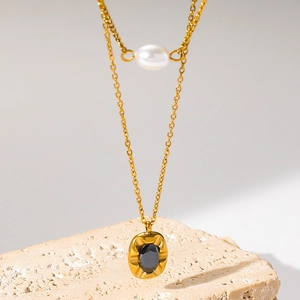 Double-layered gold stainless steel necklace with pearl and oval black gemstone pendant