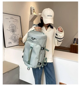 Mint green travel backpack side view on model showing light fabric and adjustable straps
