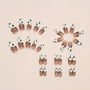 Long coffin press-on nails with french cow print tips and nude gradient base