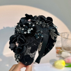 Close-up of handmade black lace flower headband featuring sparkling rhinestones and beads