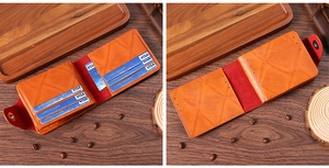 Detail of vintage orange leather wallet showing multiple card slots and metal snap button