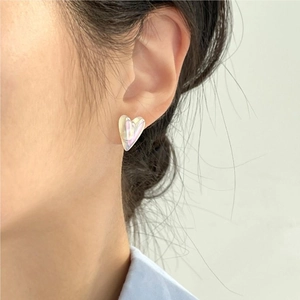 Irregular heart mermaid pearl stud earrings in 925 silver worn on model's ear