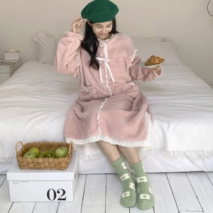 Pink coral fleece nightdress and green patterned winter socks for home warmth