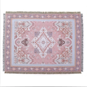 Bohemian pink and purple woven camping blanket with geometric patterns and fringe