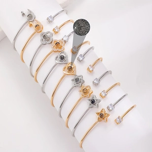 Detailed view of alloy bracelets with nano projection charms in heart and star shapes