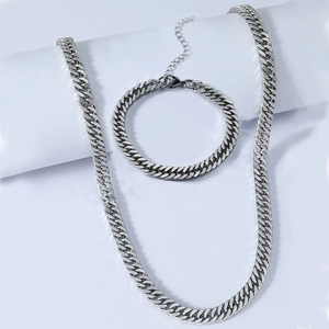 Polished silver Cuban link chain necklace and bracelet set with lobster clasp detail