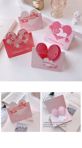 Close-up of 3D Valentine card with pink hearts, roses and a writing area for messages