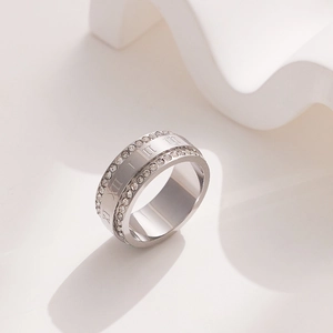 Macro detail of silver titanium ring with double rows of crystals and Roman numeral engraving