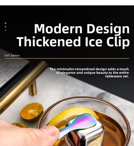 Close-up of Aurora colored stainless steel spoon with square ice cubes on marble surface