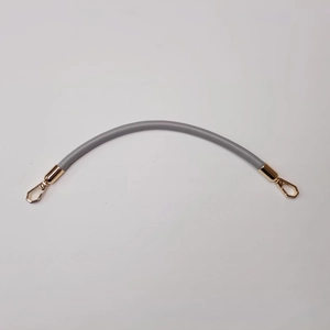 Detail of grey silicone purse handle with polished gold metal lobster clasps