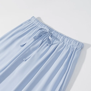 Detailed close-up of light blue elastic waistband with matching drawstring and silky fabric