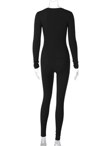 Detail shot of black ribbed knit fabric on a slim fit long sleeve bodysuit for women