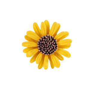 Floral sunflower brooch with bright yellow petals and textured brown center on white background